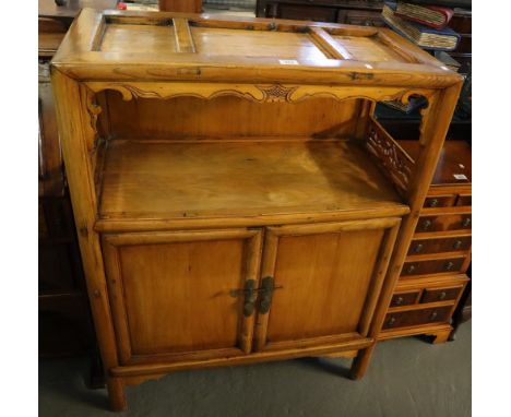 Modern oriental hardwood two tier sideboard or cabinet having two blind panelled doors on bracket feet, purchased in Hong Kon