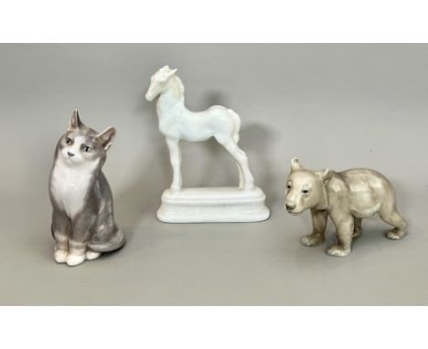 Three porcelain figures of animals - comprising a Royal Copenhagen 1803 Seated grey and white cat, 13.5cm high; a Bing &amp; 