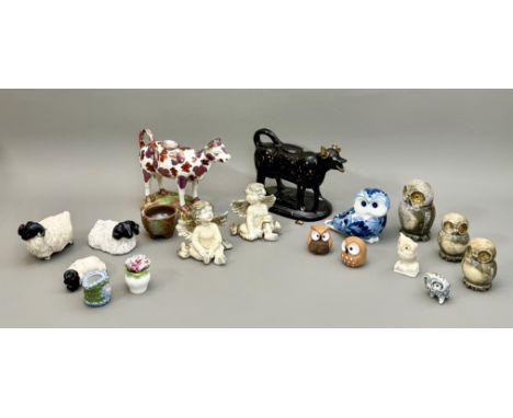 Two 19th century Staffordshire cow creamers - both a/f, one in pink lustre, brick red and white, on a green and brown glazed 