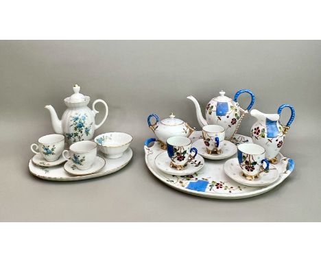 Two porcelain cabaret sets - one early 20th century, Continental, with a circular two-handled tray, coffee pot, cream jug, su