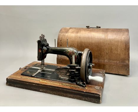 An early 20th century Frister &amp; Rossmann cast iron manual sewing machine - with floral and gilt lined decoration, folding