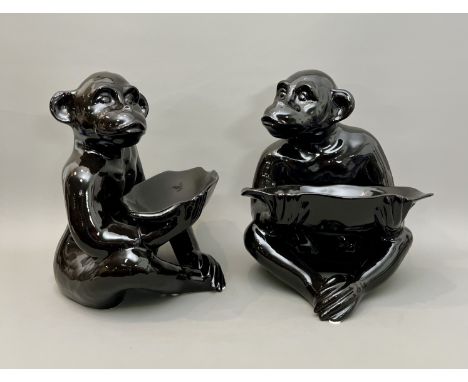 A pair of unusual serving dishes in the form of seated monkeys - late-20th century, in black glazed ceramic, 44cm high.