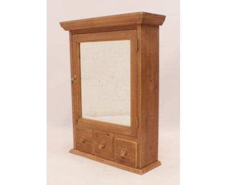 A waxed pine bathroom cabinet - with a mirrored door enclosing a single shelf, above three lower drawers. (LWH 53 x 18 x 70.5