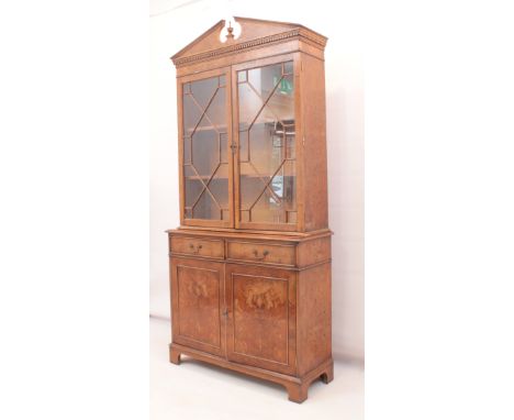 A reproduction pollard oak veneered cupboard bookcase in the George II style - second half 20th century, the architectural pe