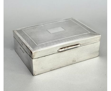 An Elizabeth II silver cigarette case - Harman Bros., Birmingham 1960, with engine turned decoration to the lid, bakelite bas