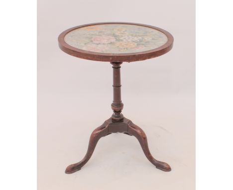 An antique mahogany wine table - the circular glazed floral tapestry top on a 19th century tripod base with three swept suppo