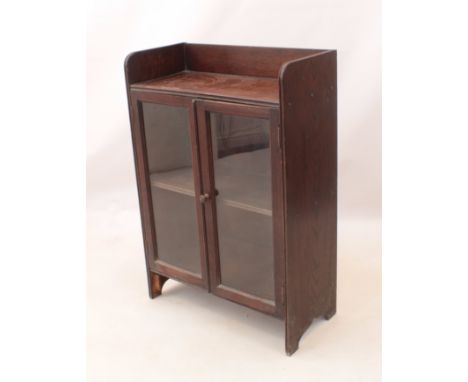 A small glazed oak bookcase - 1920s-30s, with three-quarter gallery top and single interior shelf. (LWH 60.5 x 28.5 x 89cm)