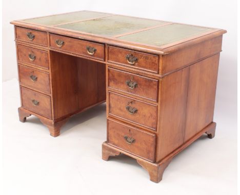 A late 19th / early 20th century mahogany pedestal desk - the moulded top with an inset gilt tooled green leather, over nine 