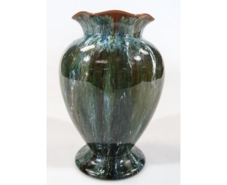 A 20thC Linthorpe pottery vase, with compressed flared rim, circular shouldered body and circular foot, in drip glazes, predo