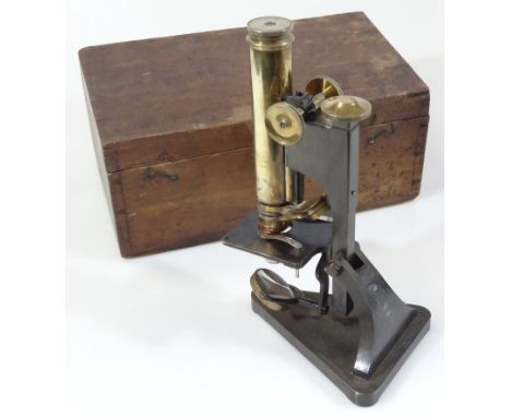 A 20thC brass microscope, with cylindrical lens, fixed stage and articulated knops, 26cm high, in fitted box, marked T Cooke 