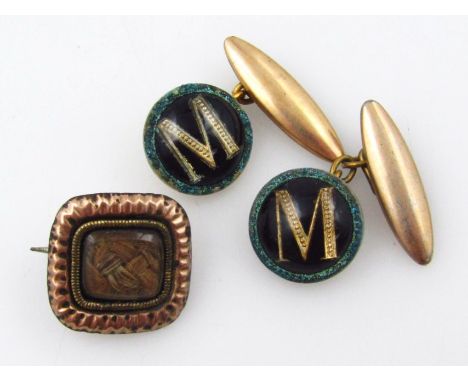 Two items of jewellery, to include a gilt metal memorial brooch and a pair of gold plated M cufflinks. 