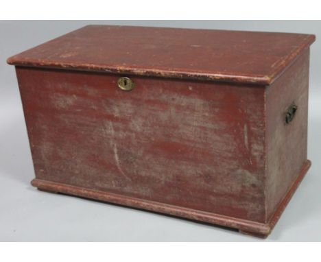 A late 19thC painted pine tool chest, the rectangular over hanging top hinging to reveal a plain interior with metal side han