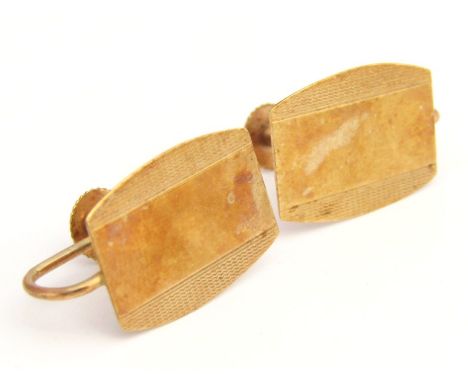 A pair of early 20thC clip cufflinks, each of shield shape outline, partially engine turned with articulated ring backs, yell