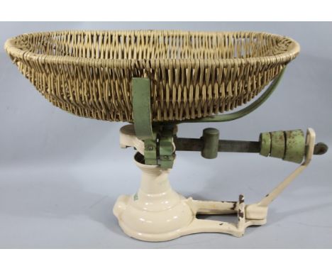 A metal Avery baby scale, in green and cream with removable basket top, marked to the top, 45cm high, 60cm wide, 28cm deep.