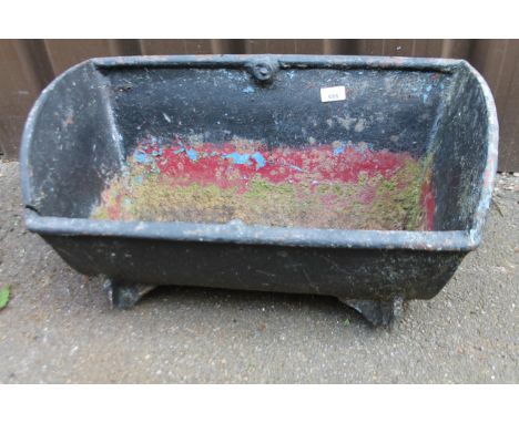 A 20thC metal animal feeding trough, painted black, 59cm wide.