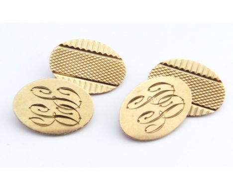 A pair of 9ct gold cufflinks, of oval outline with chain centres, partially engine turned and engraved, 2cm high, 10g, in Hew