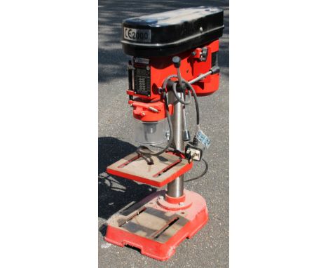 A modern CE2000 bench pillar drill, in black and red, 59cm high.
