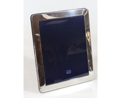 A Sterling silver photograph frame, of plain oblong outline with easel back, 30cm x 25cm, with outer packaging and box, as ne