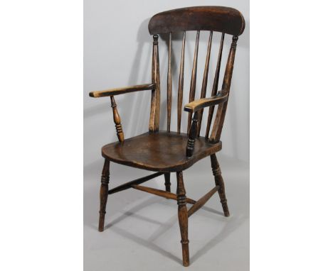 A late 19thC ash and elm comb backed grandfather chair, with spindle back, shaped arms, shaped seat and triple ring turned fr