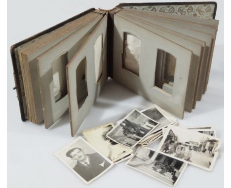 A late Victorian pressed leather photograph album, with elaborate metal clasp with sectional card interior and a quantity of 