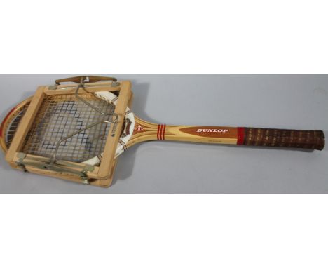 A 20thC bygone Dunlop Maxply Fort tennis racket, with leather grip and stretcher 68cm wide.