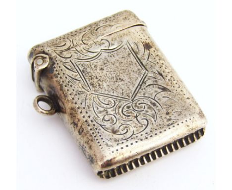 An Edwardian silver vesta case, the oblong body with match strike base, partially engine turned set with shield cartouche and