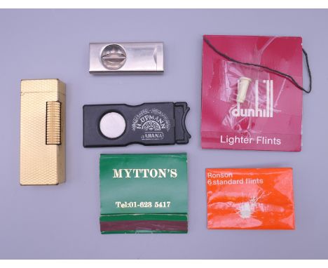 A Dunhill plated lighter, etc. 6.5 cm high.