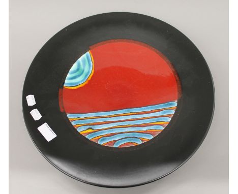 An unmarked Poole pottery charger. 41 cm diameter.