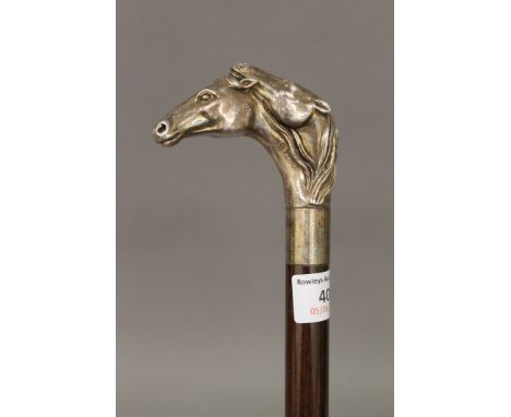 A 925 silver handled walking stick formed as two horse heads. 92.5 cm long.