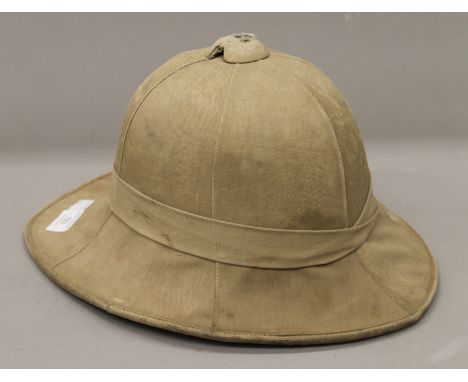 A pith helmet with wartime arrow mark.