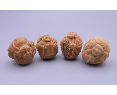 Four carved bone netsuke. Each approximately 3 cm wide.