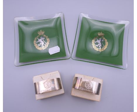 Two boxed silver napkin rings engraved for The Women's Royal Army Corps and two ashtrays. The latter each 11.5 cm wide.