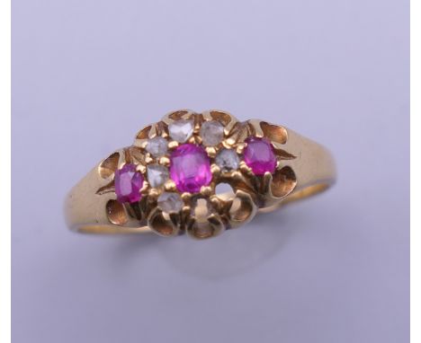 An 18 ct gold diamond and ruby ring. Ring size O. 