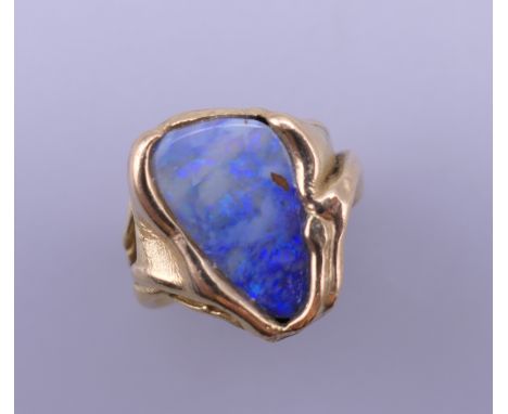 An 18 ct gold and opal ring. Ring size H/I. 10.3 grammes total weight.