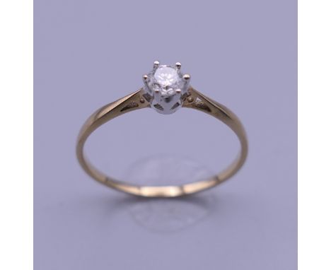 A 9 K gold 0.25 carat diamond solitaire ring. Ring size R. 1.1 grammes total weight.