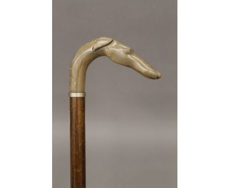 A walking stick, the handle formed as a dog's head. 91 cm long.