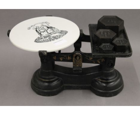 A set of Victorian grocer's scales, with ceramic plate. 35 cm wide.