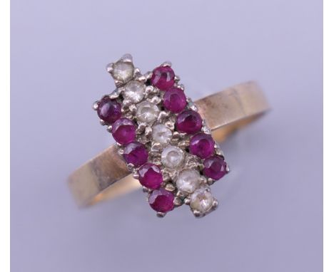 An 18 K gold ruby and diamond ring. Ring size L/M. 2.1 grammes total weight.