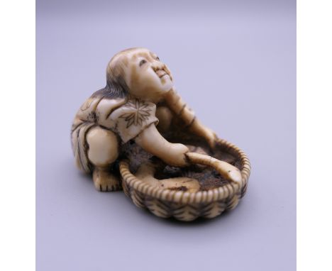 A 19th century Japanese ivory netsuke formed as a fisherman. 3 cm high.