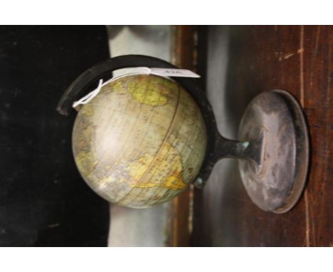 the thin globe mounted to a cast metal stand