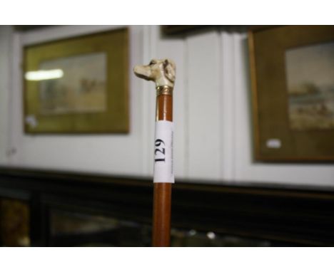 with carved ivory dogs head finial and yellow metal ferule