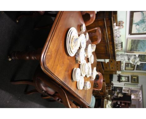 the moulded top above a plain frieze resting on turned tapering supports with ceramic castors 