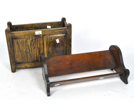An early 20th century farmhouse style oak magazine rack and a mahogany bookshelf, the magazine rack with two slots, measuring