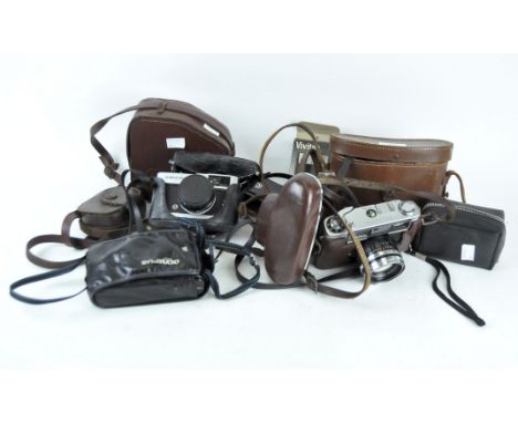 A collection of vintage cameras, including an Olympus Trip 35, a Yashica Lynx-100, Kodak Instamatic 25, Paillard Bolex and mo