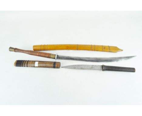 A Burmese sword, the slight curved blade on turned wooden handle, with original sheath, 75cm long, together with a similar da