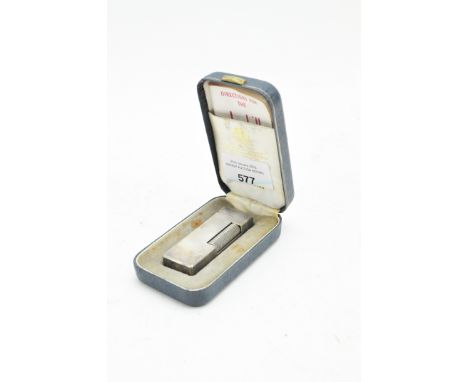 A Dunhill silver plated lighter, the exterior with textured decoration, in the original fitted box with a set of instructions