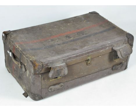 A large 20th century trunk retailed by Harrods, the exterior covered in brown flax fibre with leather handles and fastenings 