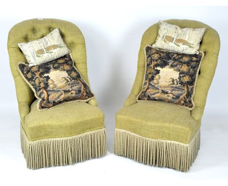 A pair of 20th century button back chairs, each upholstered in pale green/yellow fabric with firning to front, with tapestry 