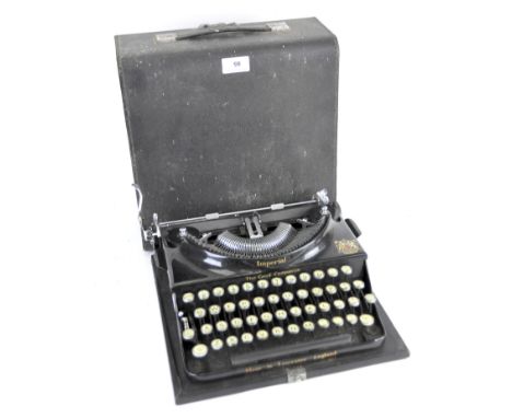 A vintage Imperial typewriter, in black with gilt details and the Royal crest, in the original carrycase, width 31cm Conditio