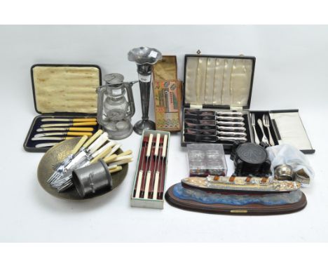 Assorted collectables and silver plate to include boxed and loose cutlery, a model Titanic, napkin rings, and more